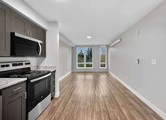 A kitchen with a stove top oven and microwave.