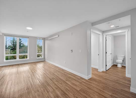 A room with a toilet and a window.
