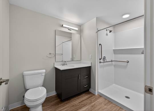 A white toilet sits next to a sink in a bathroom.