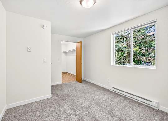 A room with a window and a door.