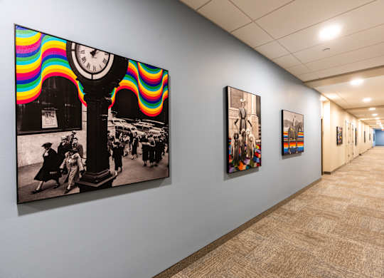 A hallway with a series of pictures on the wall.