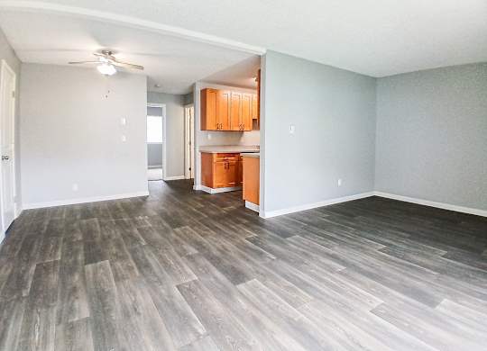 A room with wooden flooring and a ceiling fan.