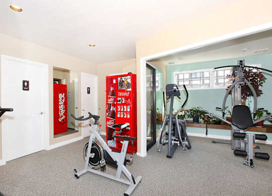 A gym with a Coca Cola vending machine.