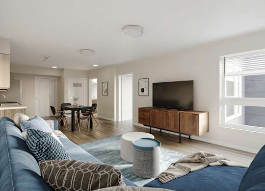 A modern living room with a blue sofa and a television.