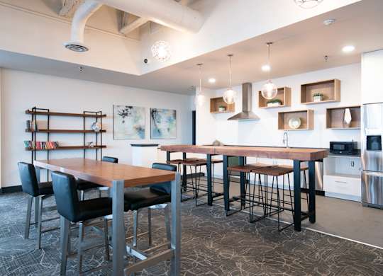 A modern kitchen with a dining table and chairs.