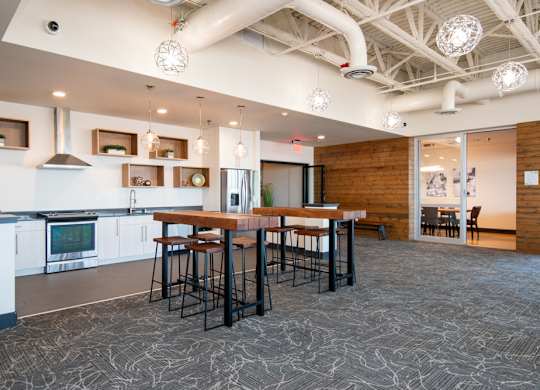 A kitchen with a bar area and a dining table.