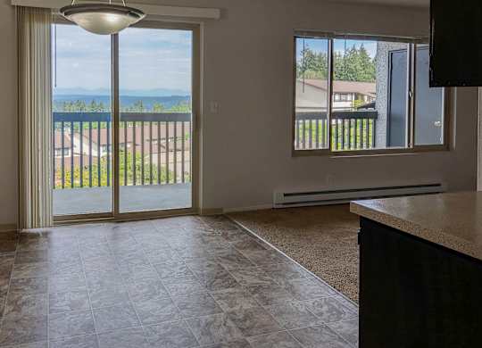 A room with a sliding glass door leading to a balcony.
