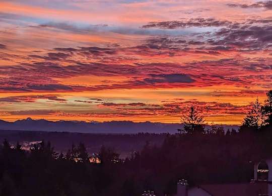 A beautiful sunset with a mix of orange, pink, and purple hues in the sky.