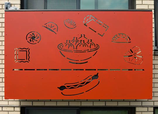 A red sign with black food drawings on it.