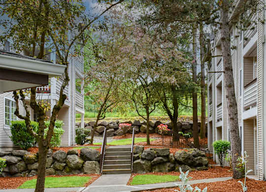 A residential area with a stone wall and a staircase.