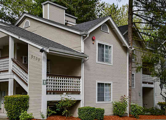 A two-story house with a balcony on the second floor.