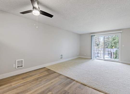 A room with a ceiling fan and a window.