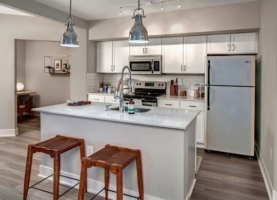 A kitchen with a white countertop and a refrigerator.