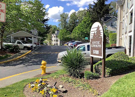A sign for Buster Commons is in front of a building.