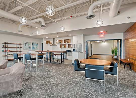 A modern office space with a patterned carpet and a variety of seating options.