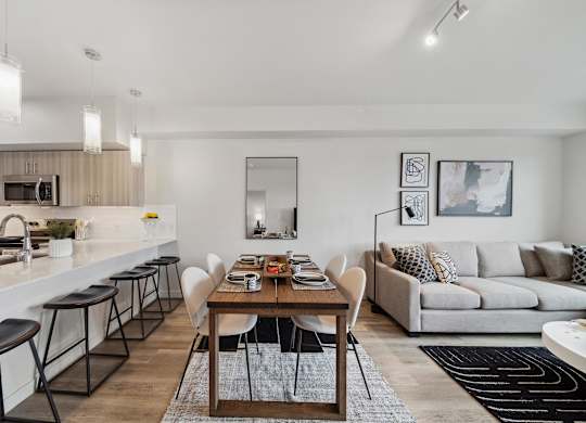 A modern kitchen with a dining table and chairs.