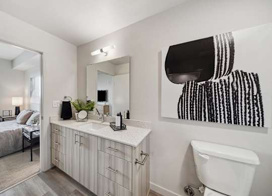 A bathroom with a white toilet and a white sink.