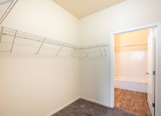 A white wall with a metal rack on it.
