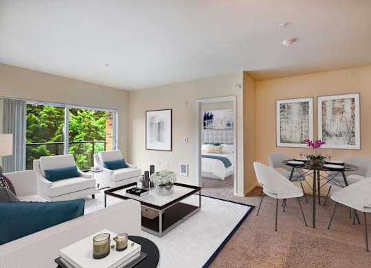A living room with a white couch, a coffee table, and a dining table with chairs.