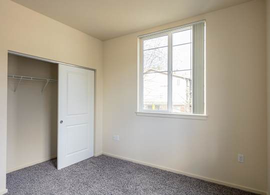 A room with a white door and a window.