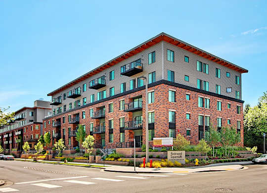 A large red brick building with a sign that says "Ballston" on it.