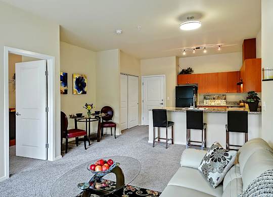 A living room with a white couch and a bar area.
