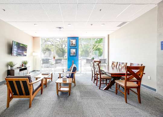 A conference room with a long table and chairs.