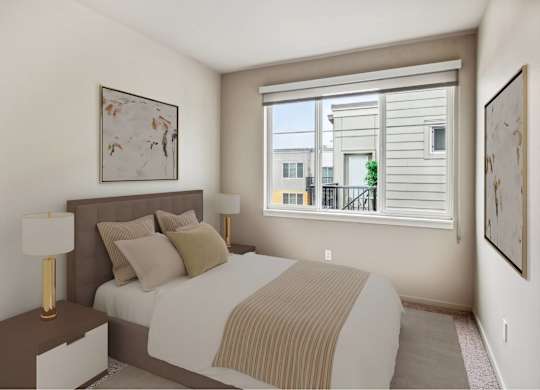 A bedroom with a large bed and a window overlooking a balcony.