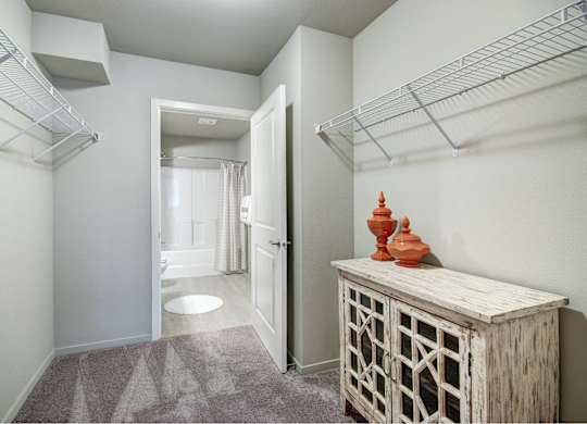 A hallway with a wooden cabinet and a carved object on top of it.