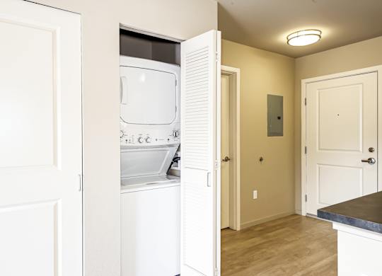 A white oven and microwave are installed in a kitchen.
