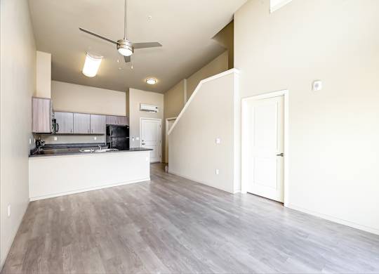 A spacious kitchen with a fan on the ceiling.