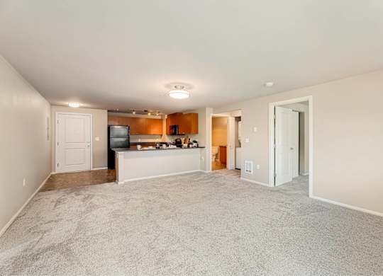 A living room with a television and a bar area.