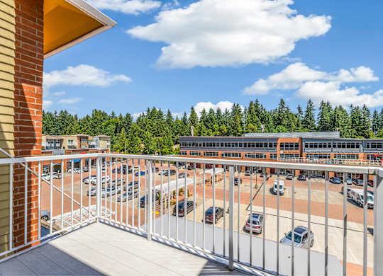 A parking lot with cars and a building in the background.