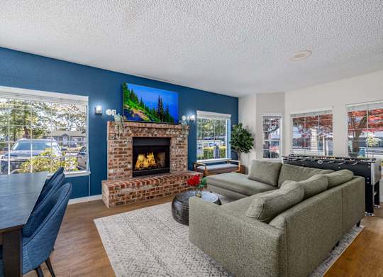 A living room with a fireplace and a painting on the wall.