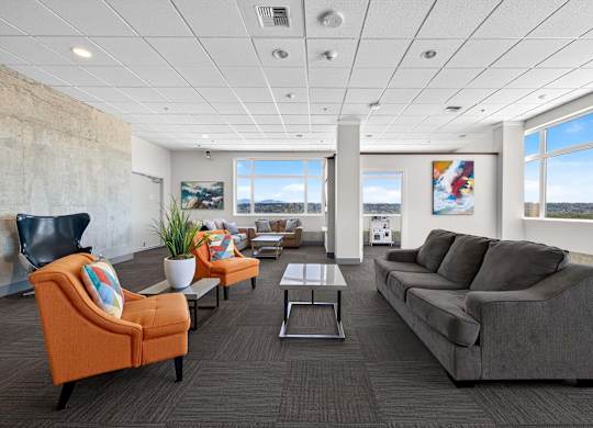 A living room with a grey couch, orange armchair, and a coffee table.