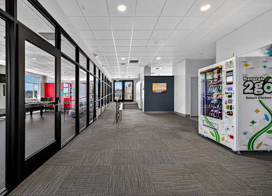 A long hallway with a vending machine on the right.