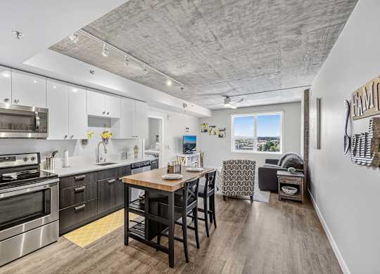 A modern kitchen with a dining area and a couch.