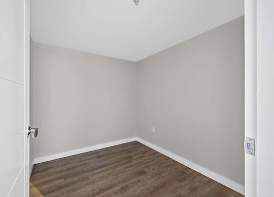A room with a wooden floor and white walls.