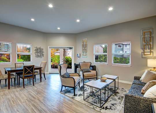 A living room with a couch, chairs, and a coffee table.