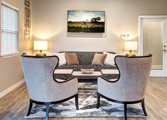 A living room with two chairs and a couch.