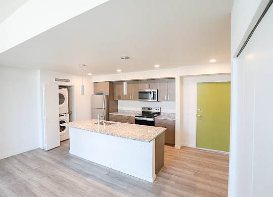 A kitchen with a white island in the middle of the room.