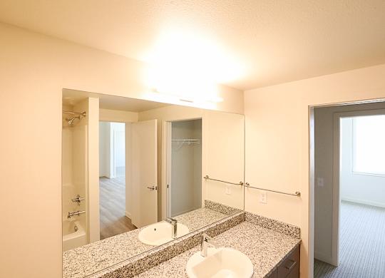 A bathroom with a sink and mirror.