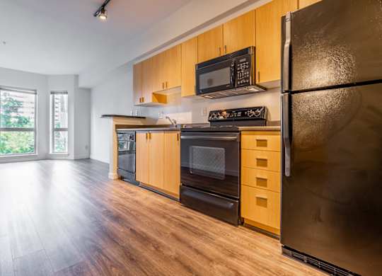A kitchen with wooden cabinets and stainless steel appliances.