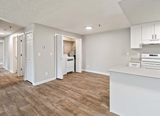 A kitchen with white cabinets and a white counter top.