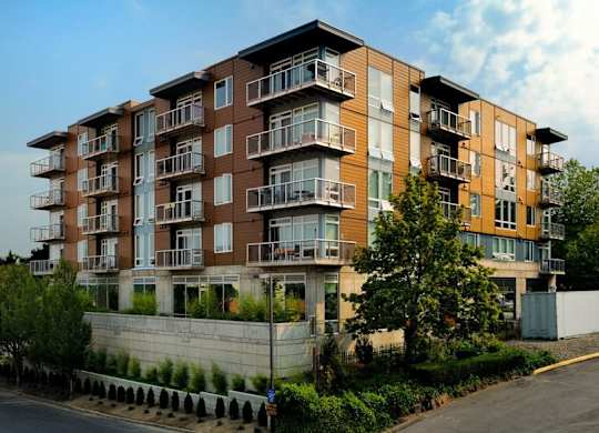 A large apartment building with balconies and multiple stories.