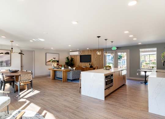 A modern kitchen with a dining table and chairs.