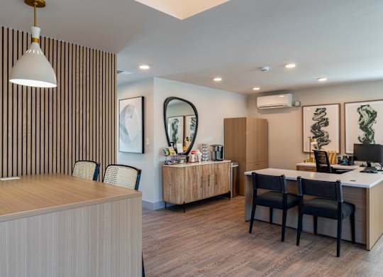 A modern office with a striped wallpaper and a wooden desk.