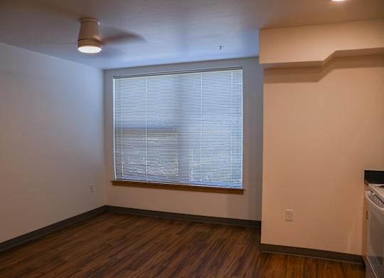 A room with a window and a ceiling fan.