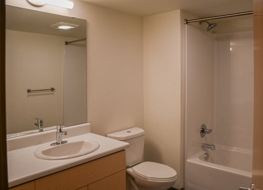 A bathroom with a sink, toilet, and bathtub.