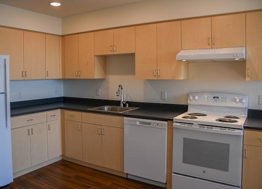 A kitchen with wooden cabinets and white appliances.